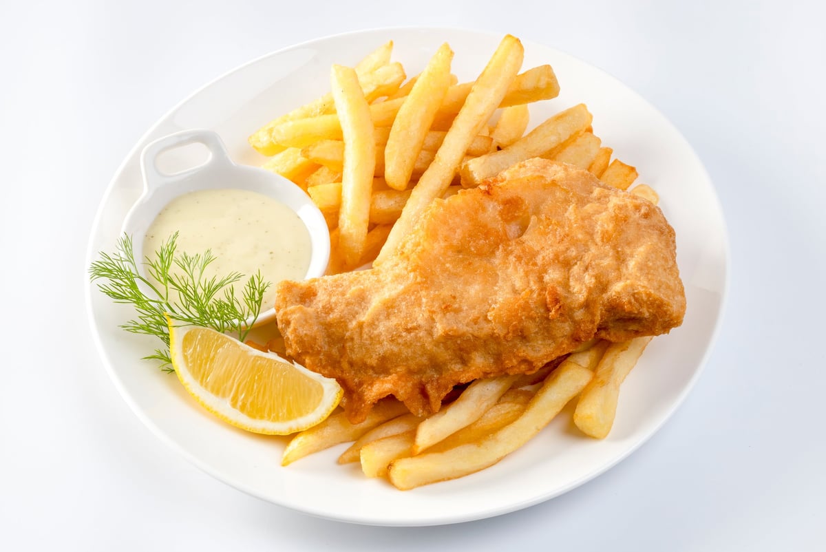 Golden battered fish and chips served with fries, tartar sauce and lemon