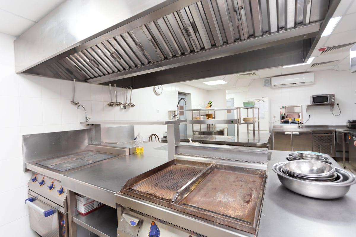 Professional stainless steel kitchen with cooking appliances